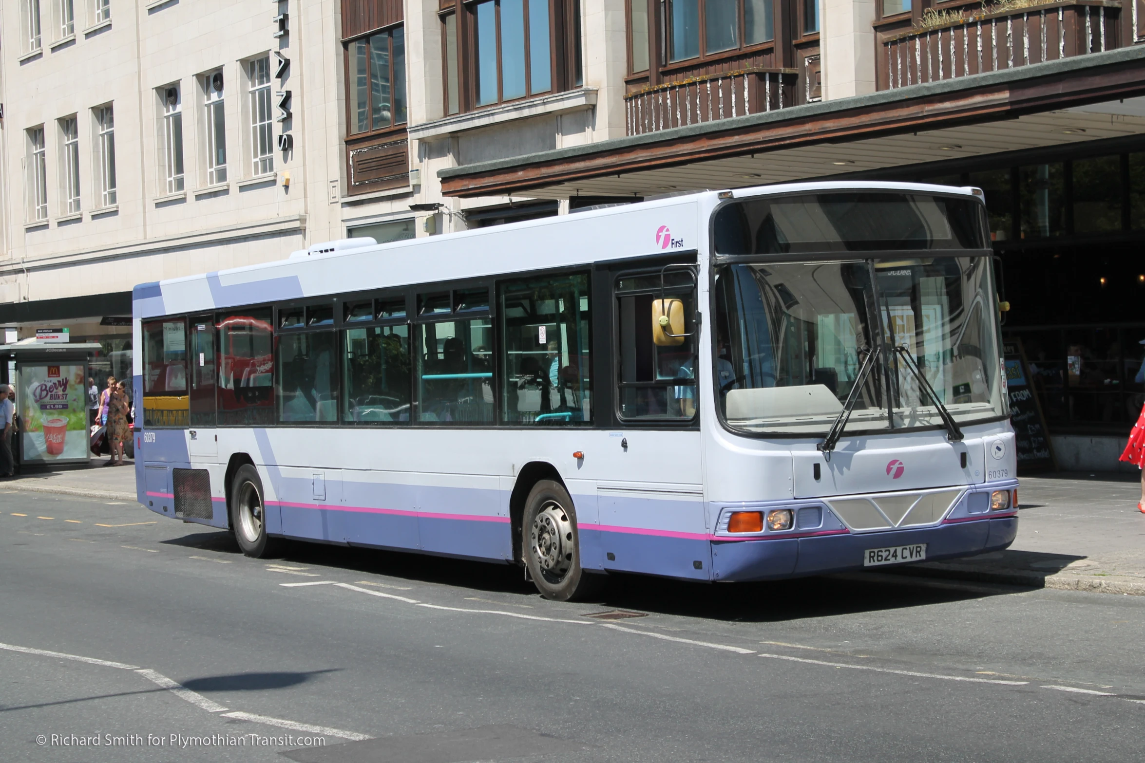 a city bus is pulled up to a stop