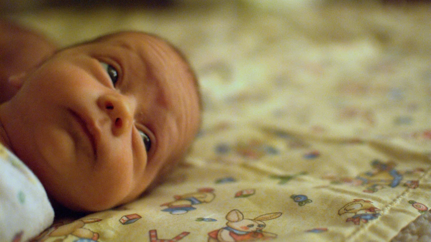 the baby looks as if it is happy with all the toys