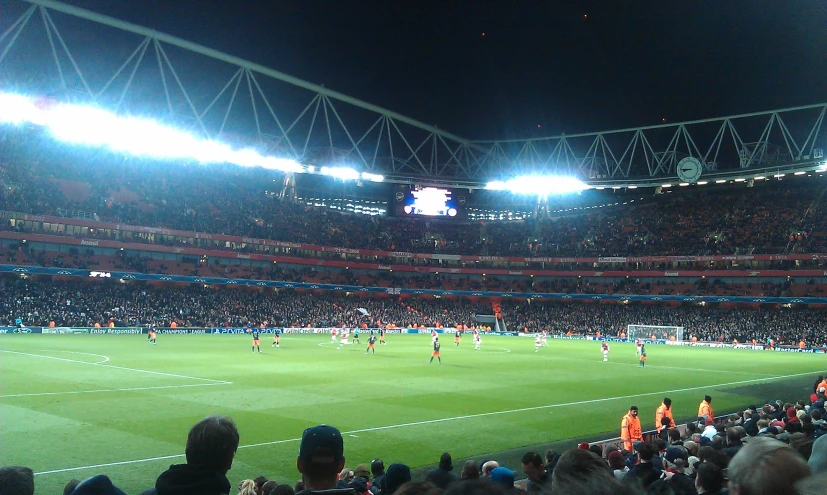 a soccer field full of people and lots of lights