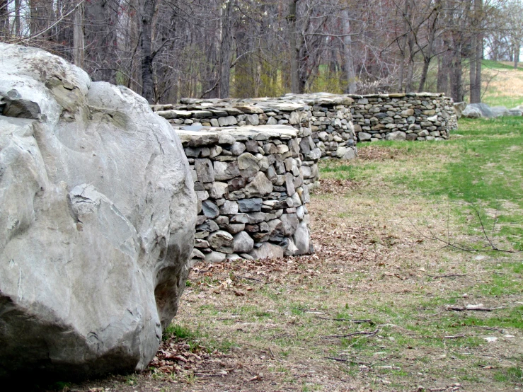 a stone wall made from stones surrounded by trees