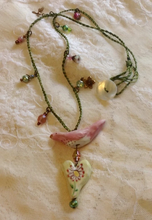 a necklace with glass charms and a leaf