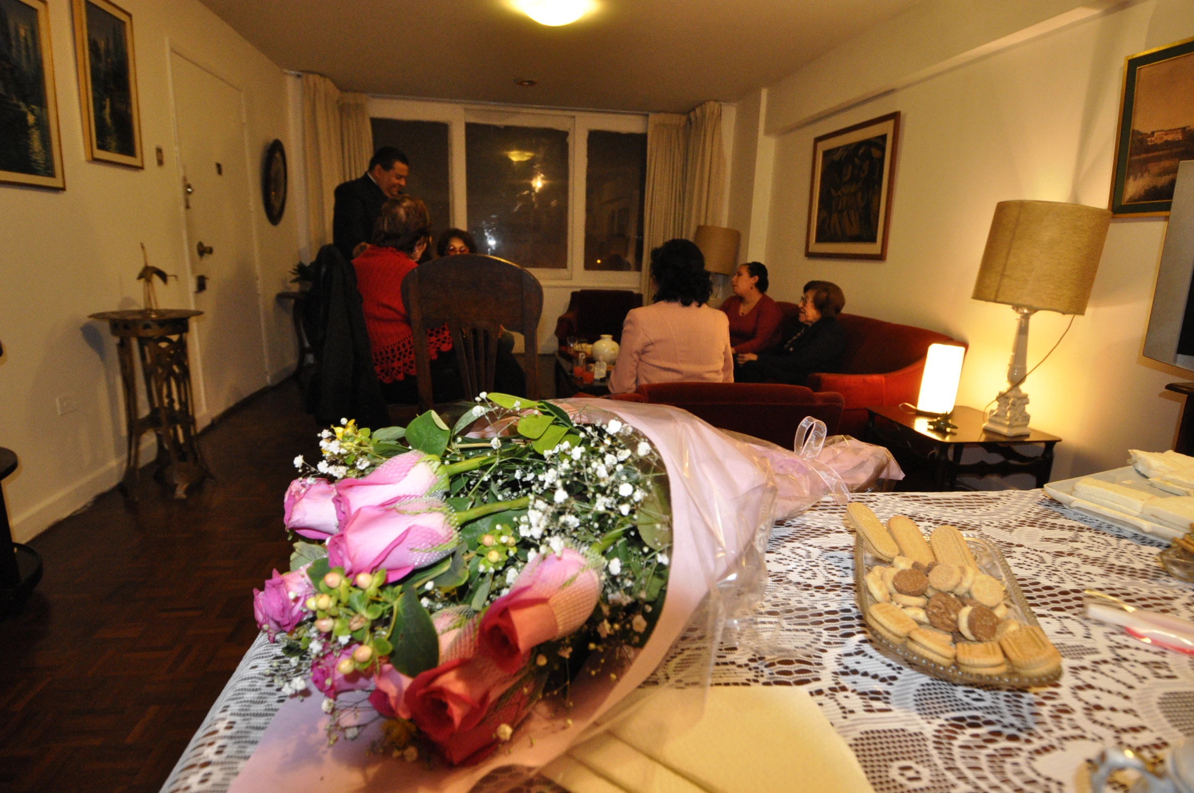 people are looking around the room from behind a table