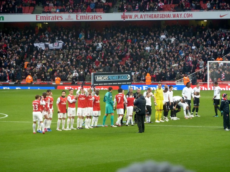 a group of players are talking on the field