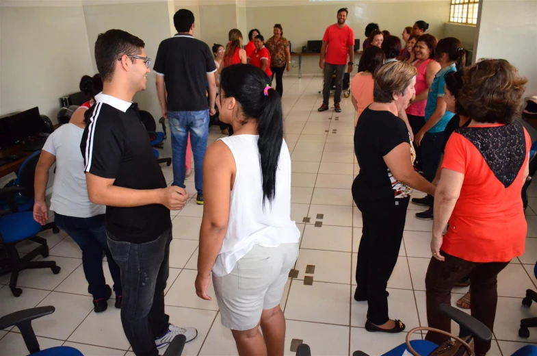 people gather in an office building while people in the background watch