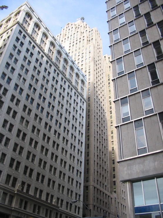 an image of some tall buildings looking up