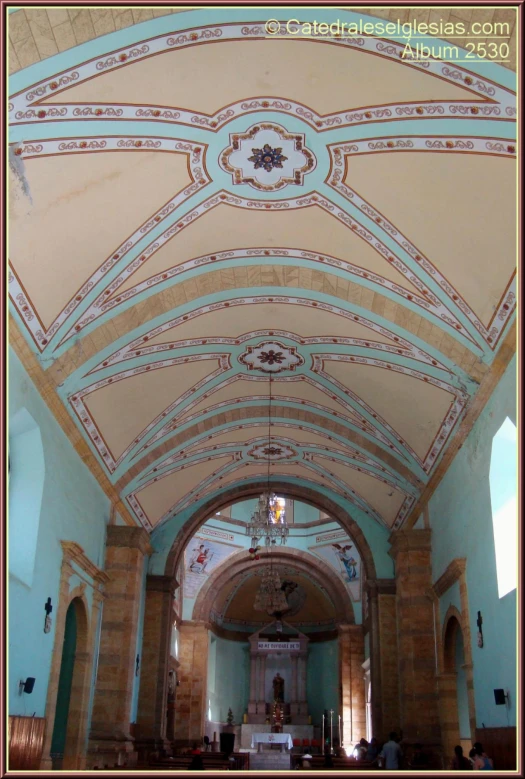 a church has a beautiful vaulted ceiling and stained glass