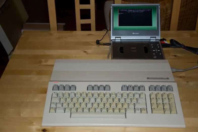 a computer sitting on top of a wooden table