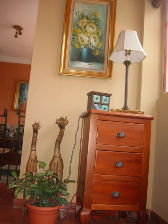 a lamp sitting on top of a table next to a wooden dresser