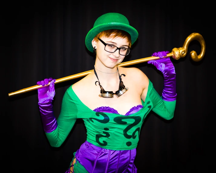 woman in green and purple outfit holding up an umbrella