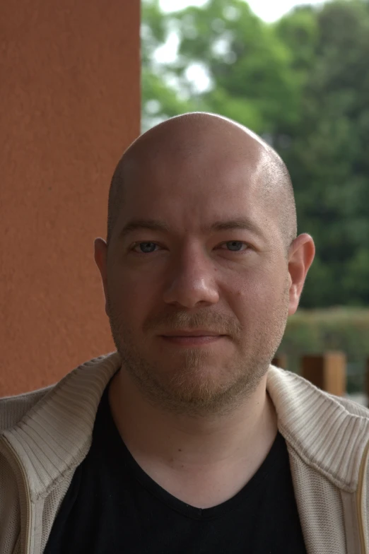 an image of a bald man with a black t - shirt