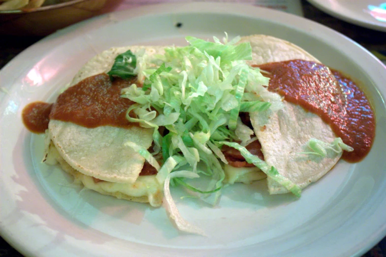 a close up of a plate of food with cheese and toppings