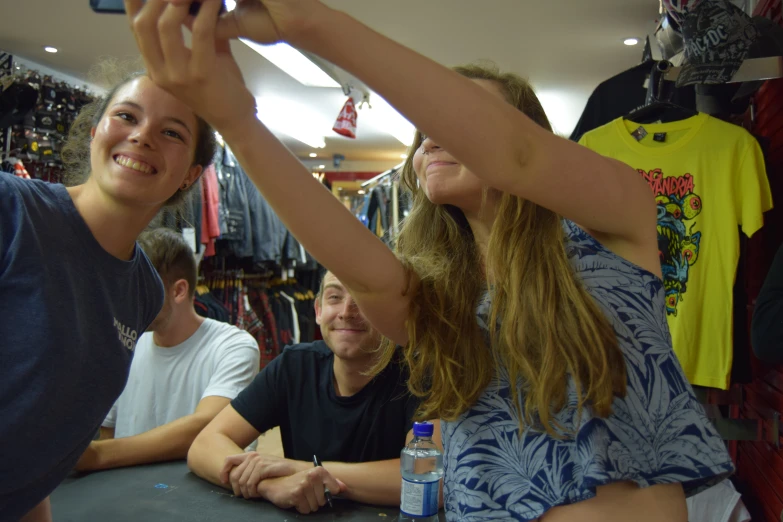 three people taking pictures in a store