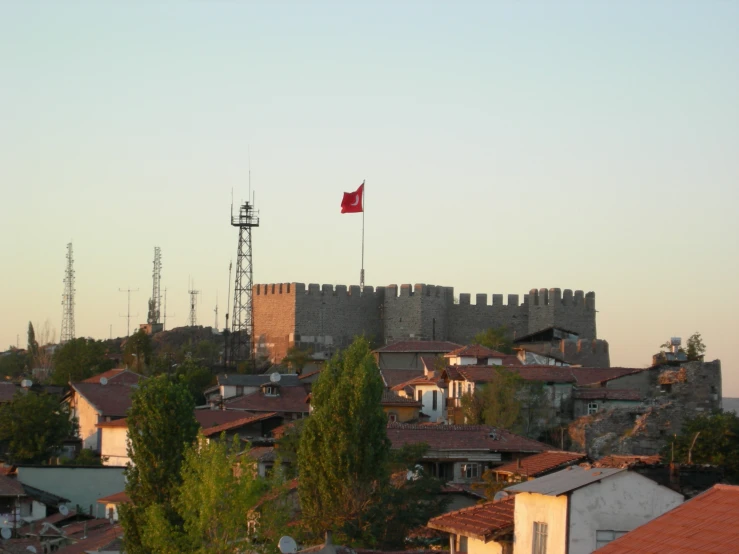 a red flag and a cityscape with a tower on top