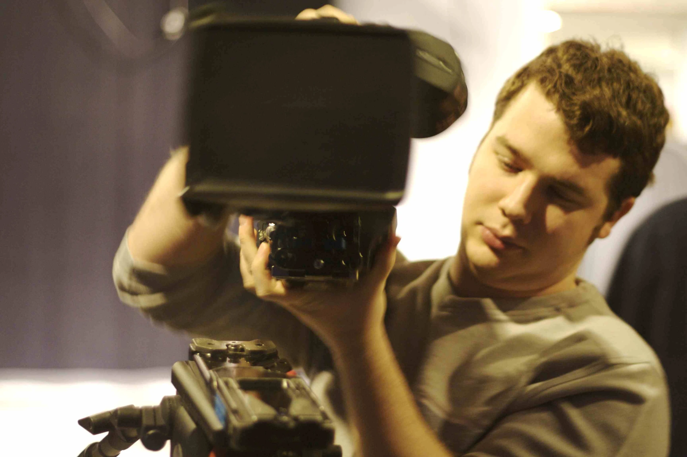 a man is holding a camera up to the side