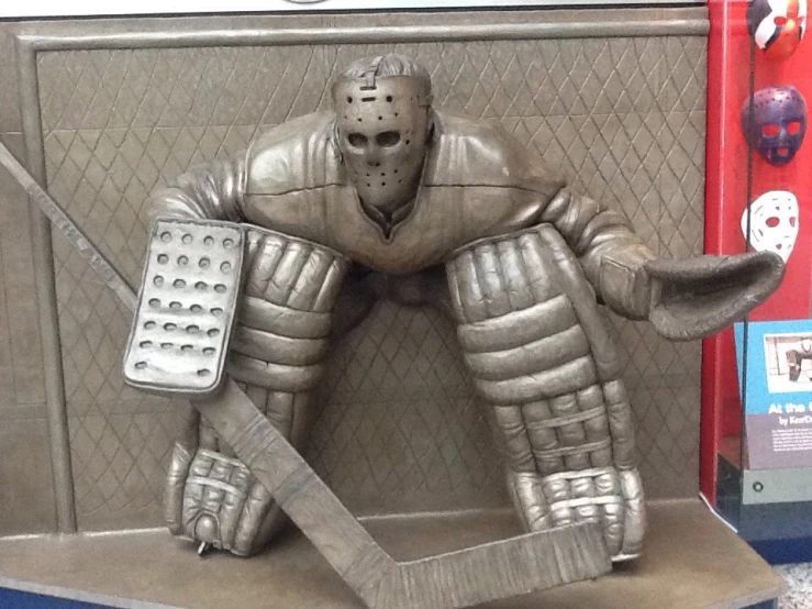 an ice hockey statue sits next to the wall
