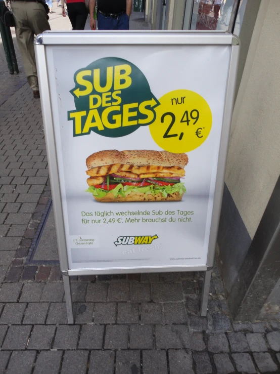 a sub restaurant sign for sale on the side of the street