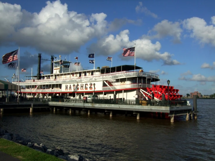 the large river boat has three american flags on it