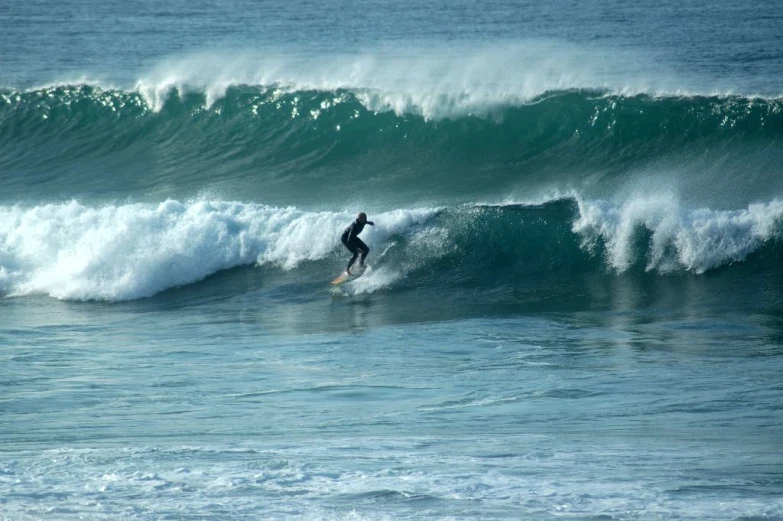 a person on a surf board riding a wave