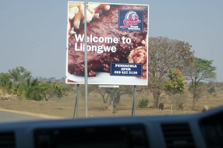 the banner is advertising a car drive past the road