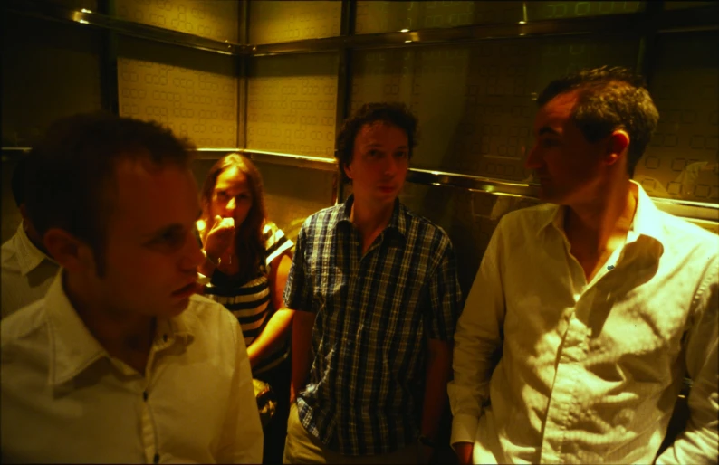 a group of people standing together in a kitchen