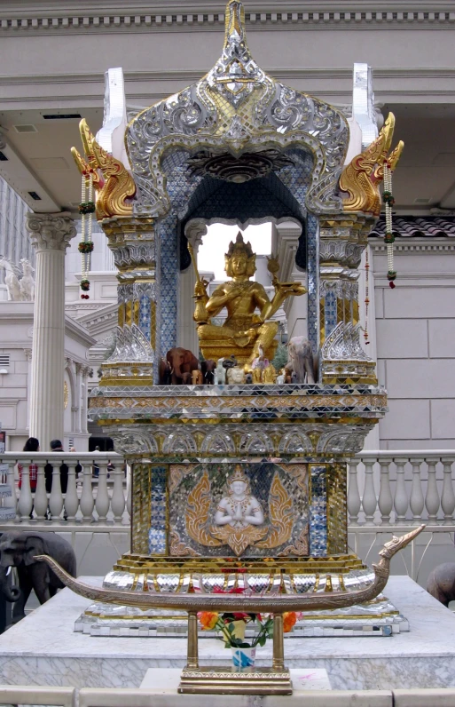 an elaborate gold and blue sculpture sitting on a table