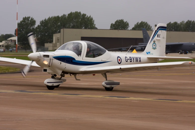 a small white plane on a landing strip