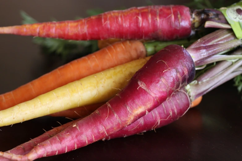 some very colorful vegetables laying next to each other