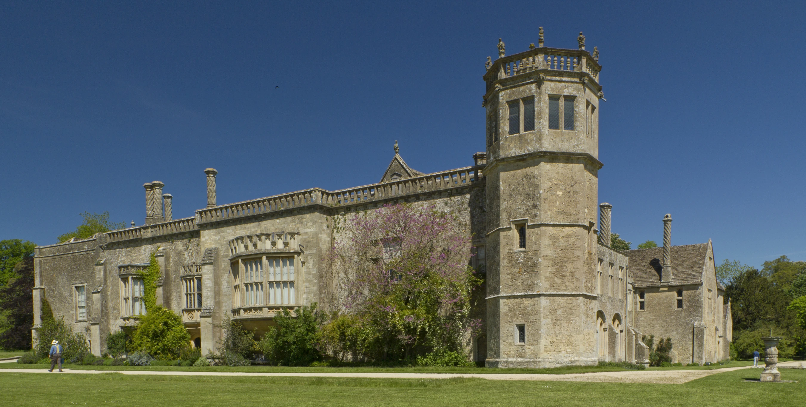 an old building with green grass in front