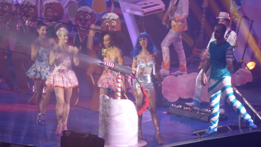 several people dressed in costume and wigs on stage