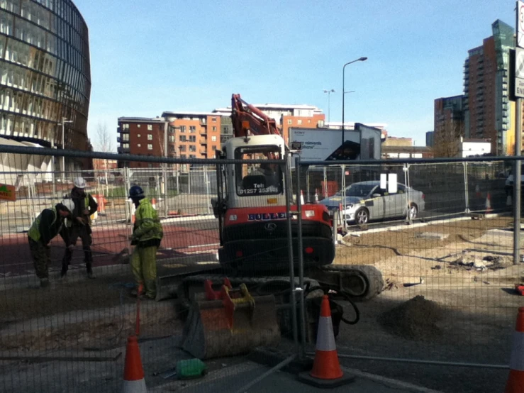 some men working outside by a construction site