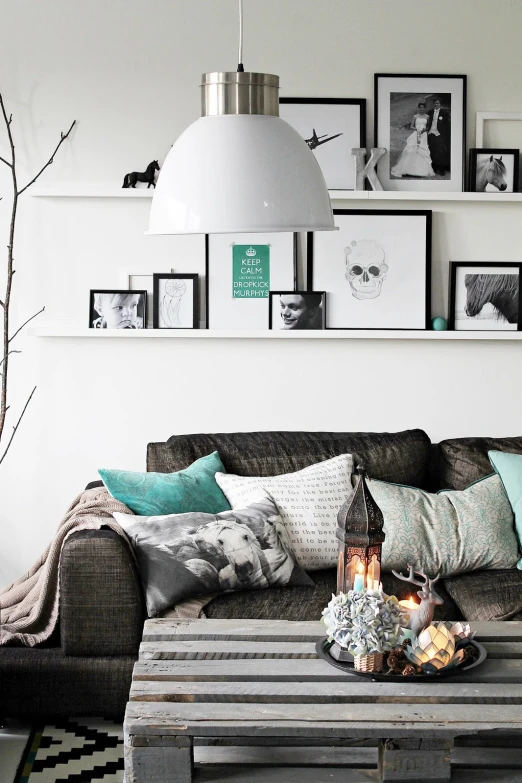 a very cozy living room with a grey couch