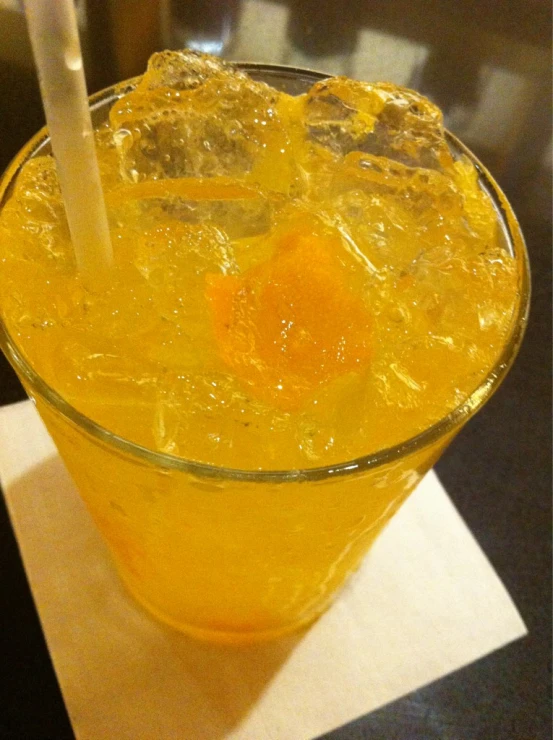 a drink with an orange substance in it on a table