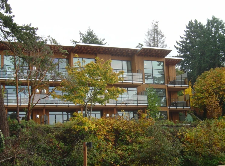 a tall building sitting on the side of a lush green forest