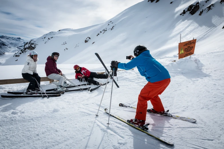 three people on skies are getting ready to ski down a hill