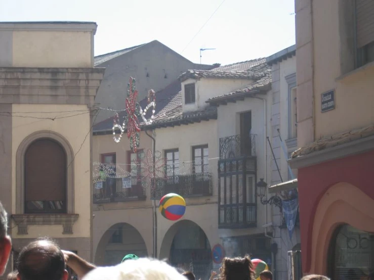 people are watching a large colorful ball float in the air