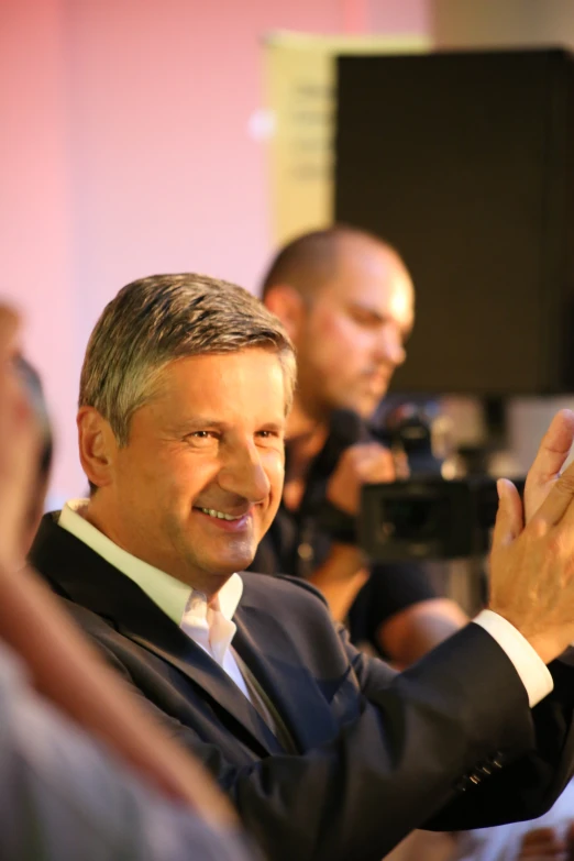 a man that is standing up in front of a camera