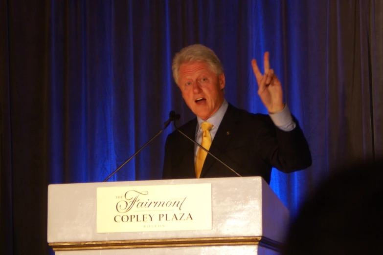 the man in a suit and tie is giving a speech