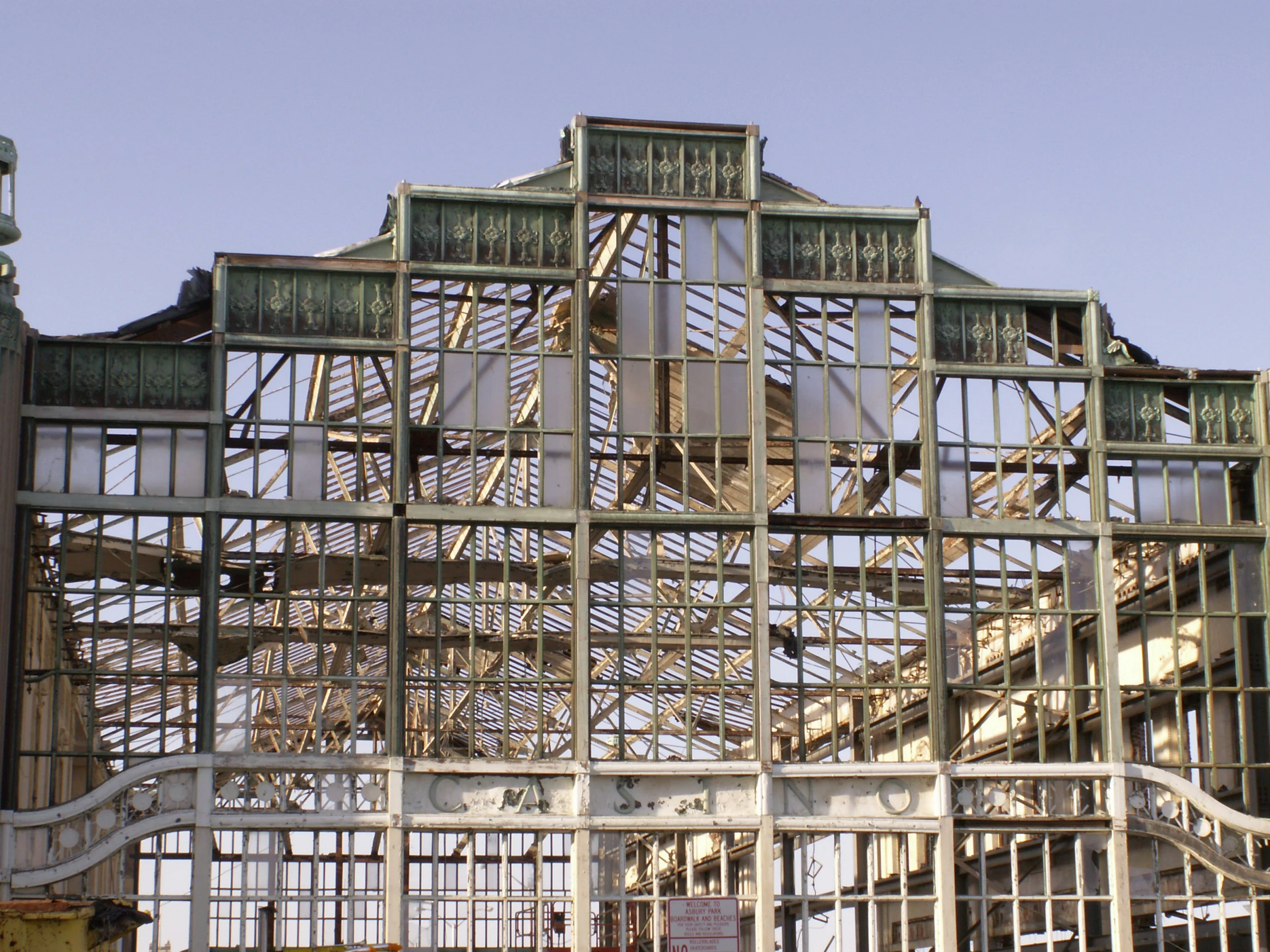 an abandoned building with metal frameworks and windows