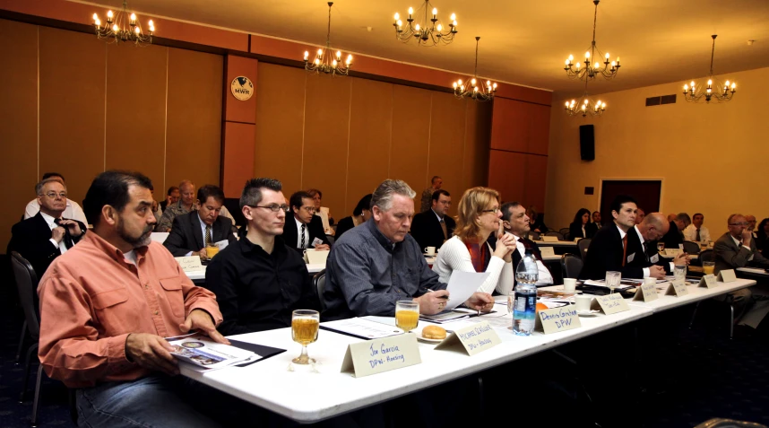 a group of people sitting at a conference table