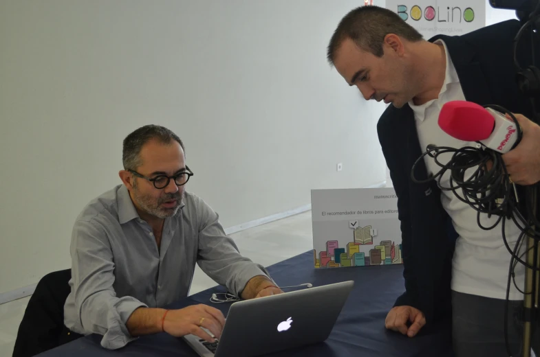 two men in a small room with some tables