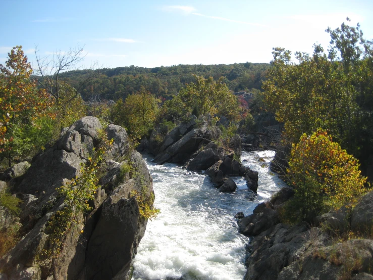 a river cuts through some rocks with white water