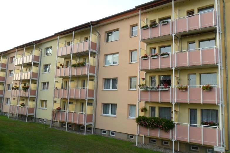 a row of pink and yellow apartment buildings