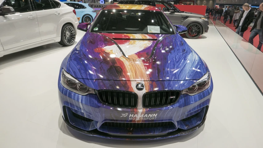 four bmw cars on display at an automobile show