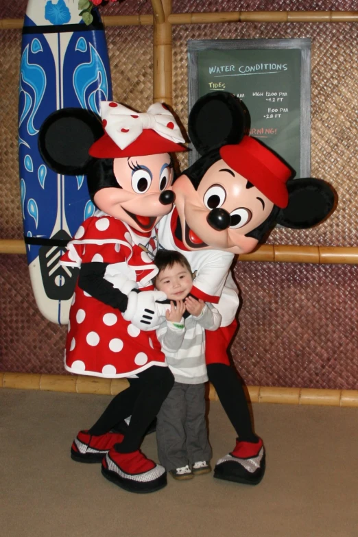 a mother and her toddler with mickey and minnie mouse