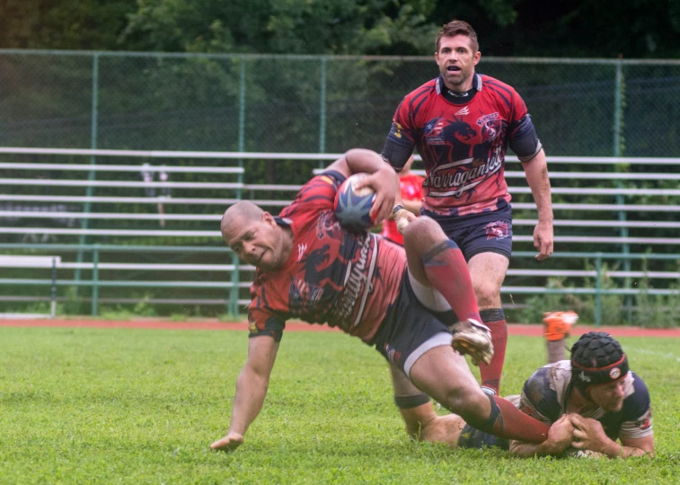 there are two men that are playing rugby