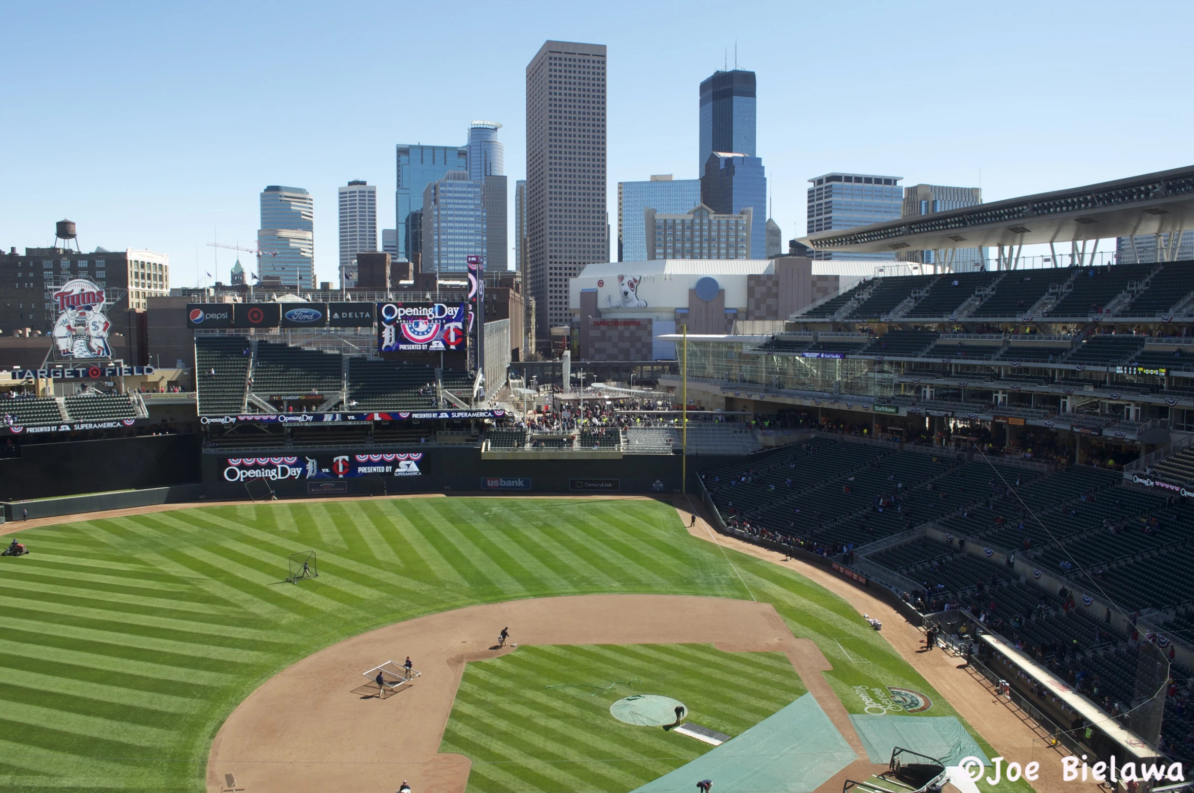 a baseball field in a city with lots of tall buildings