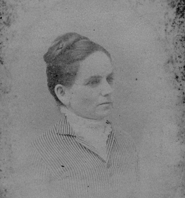 an old pograph of a woman in a striped shirt