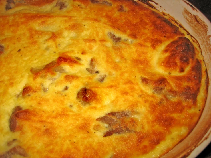 a close up of a pie with cheese and sausage