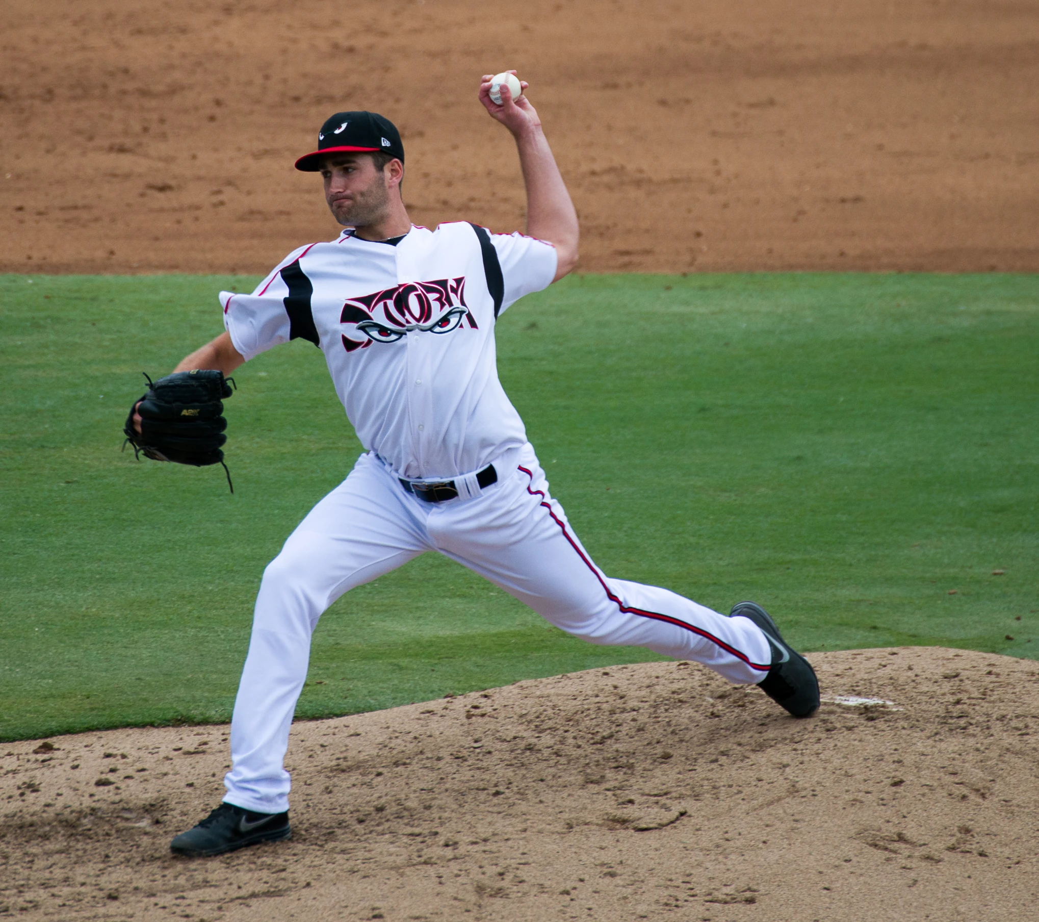 a baseball player throwing a pitch from the mound