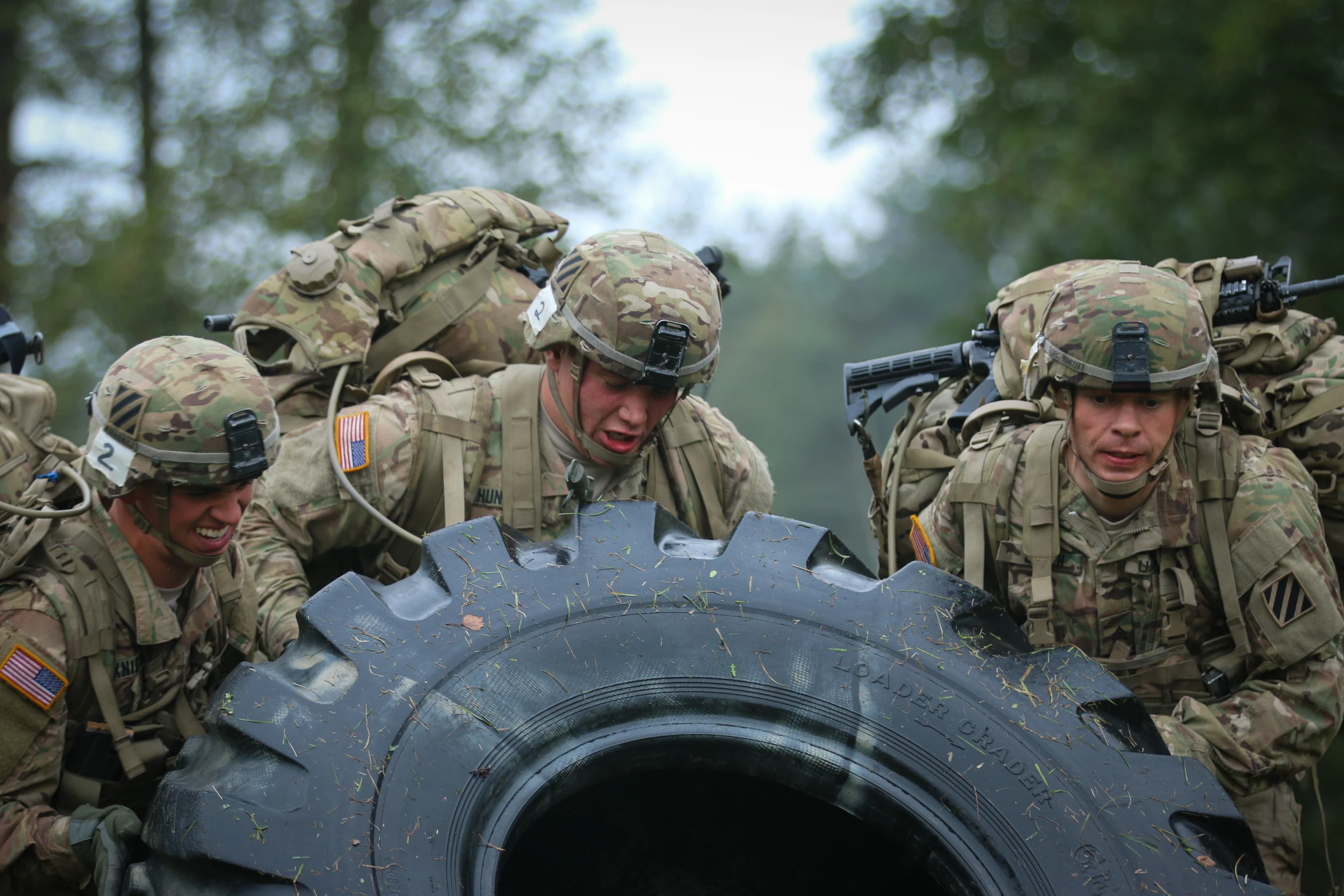 us army soldiers are putting inside a huge tire